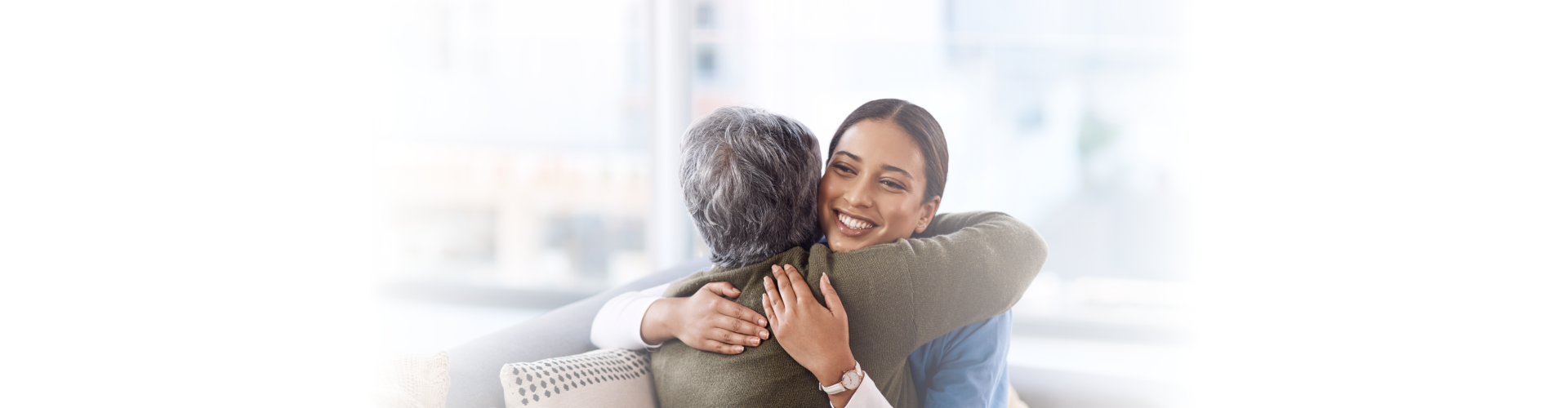 Caregiver hugging a senior woman