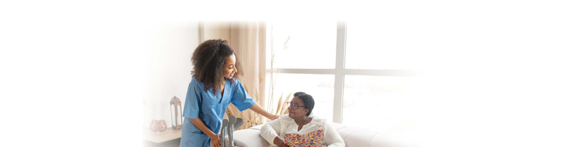 elderly with leg injury lying on sofa and talking to caregiver